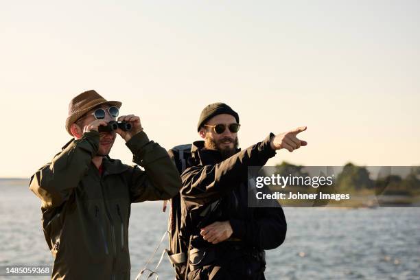 view of men standing at sea - fågelskådning bildbanksfoton och bilder