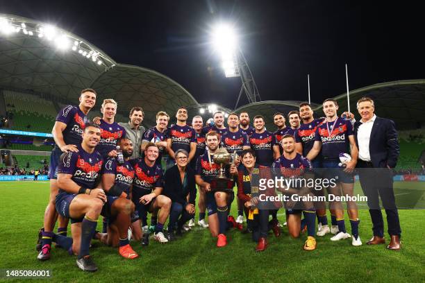 The Storm pose with the Michael Moore Trophy following victory in the round eight NRL match between Melbourne Storm and New Zealand Warriors at AAMI...