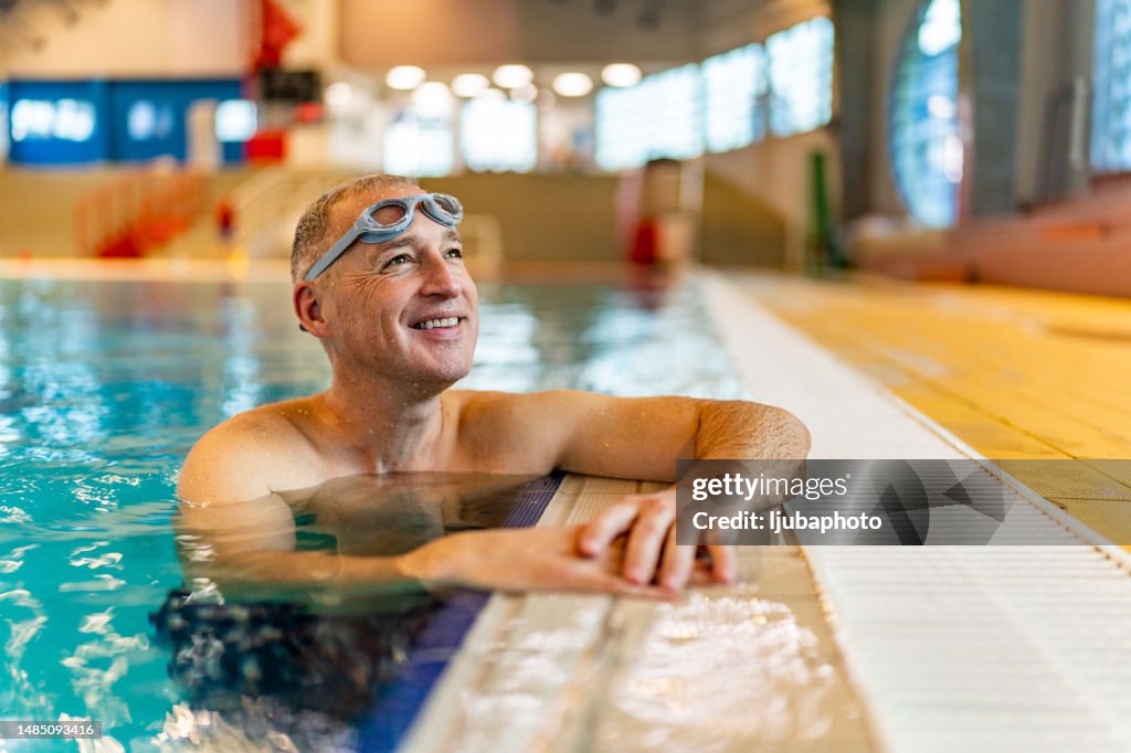 Mature man enjoying sunny day at the indoor pool