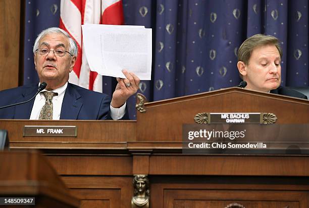 House Financial Services Committee ranking member Rep. Barney Frank holds up a copy of 'The Semiannual Monetary Policy Report to the Congress' during...