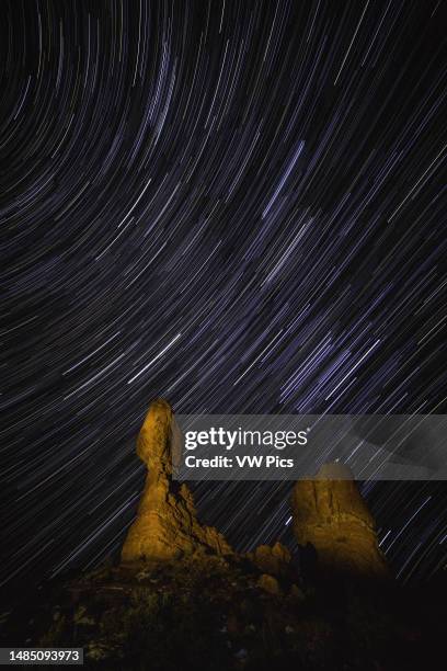 Star trails over Balanced Rock in Arches National Park near Moab, Utah, USA.