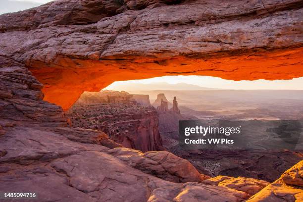 Mesa Arch at sunrise with the Washer Woman Arch, Monster Tower & Airport Tower. Canyonlands National Park, Utah.