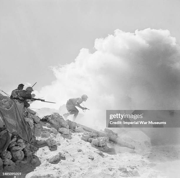 Australian soldiers attack a German strongpoint through a dense smoke screen to pave way for a further advance, during the Second Battle of Alamein,...