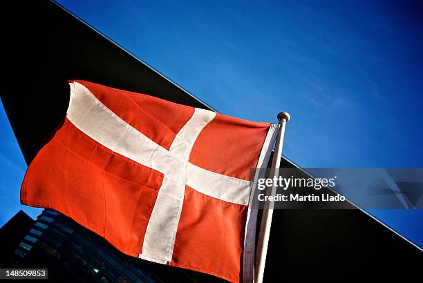 danish flag outside copenhagen opera house, holmen. - danish flags stock-fotos und bilder