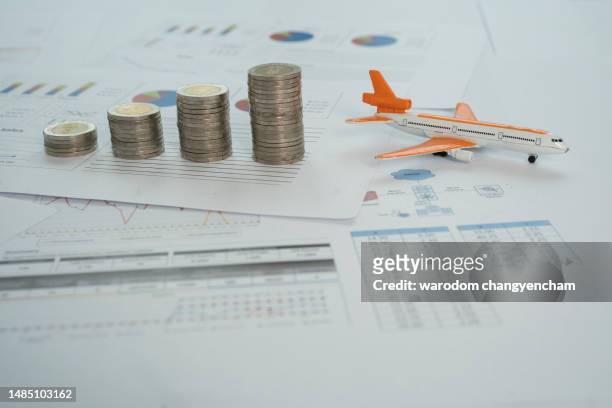 close-up of coins and model airplane on table. - modellflygplan bildbanksfoton och bilder
