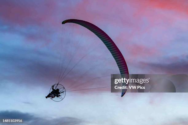 Powered paraglider flying at sunset near Hanksville, Utah.