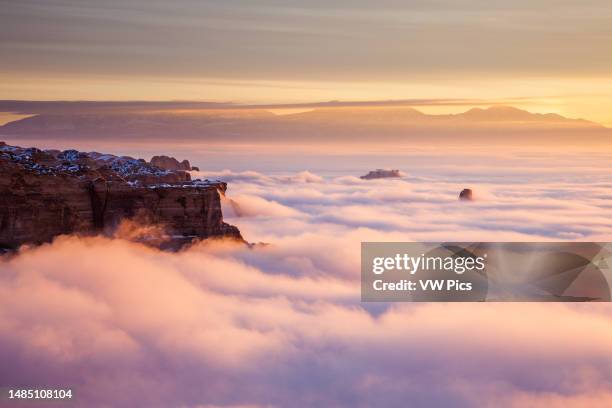 Sea of clouds near Mesa Arch at sunrise in winter in the Island in the Sky District of Canyonlands National Park, Utah.