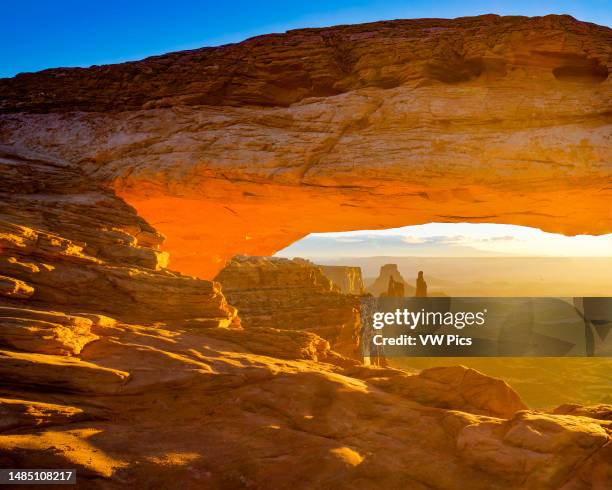 Mesa Arch at sunrise with the Washer Woman Arch, Monster Tower & Airport Tower. Canyonlands National Park, Utah.