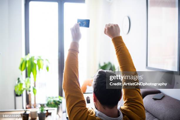 happy man holding a credit card. - game of chance stock pictures, royalty-free photos & images