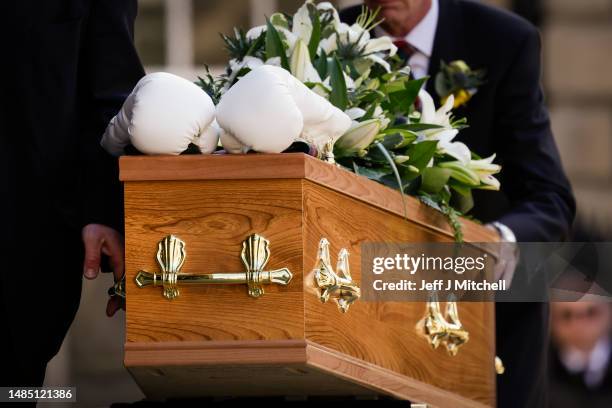 White boxing gloves lie on the coffin as it arrives for the funeral ceremony of Ken Buchanan at St Giles’ Cathedral on April 25, 2023 in Edinburgh,...