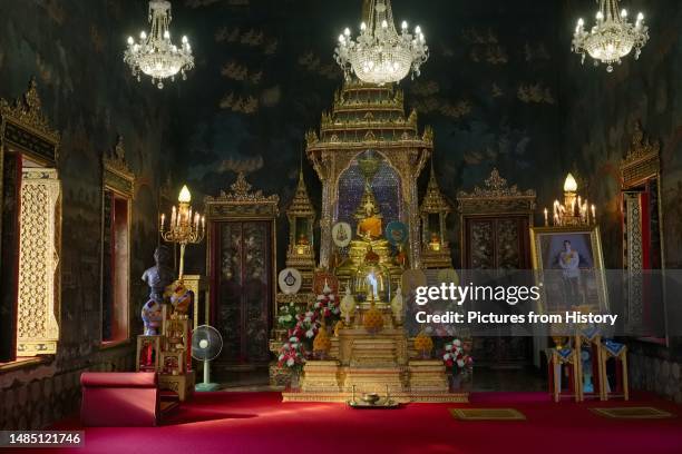 Prayer shrine at Wat Ratchapradit in Bangkok, Thailand, a portrait of King Maha Vajiralongkorn on the right. Wat Ratchapradit was constructed in the...