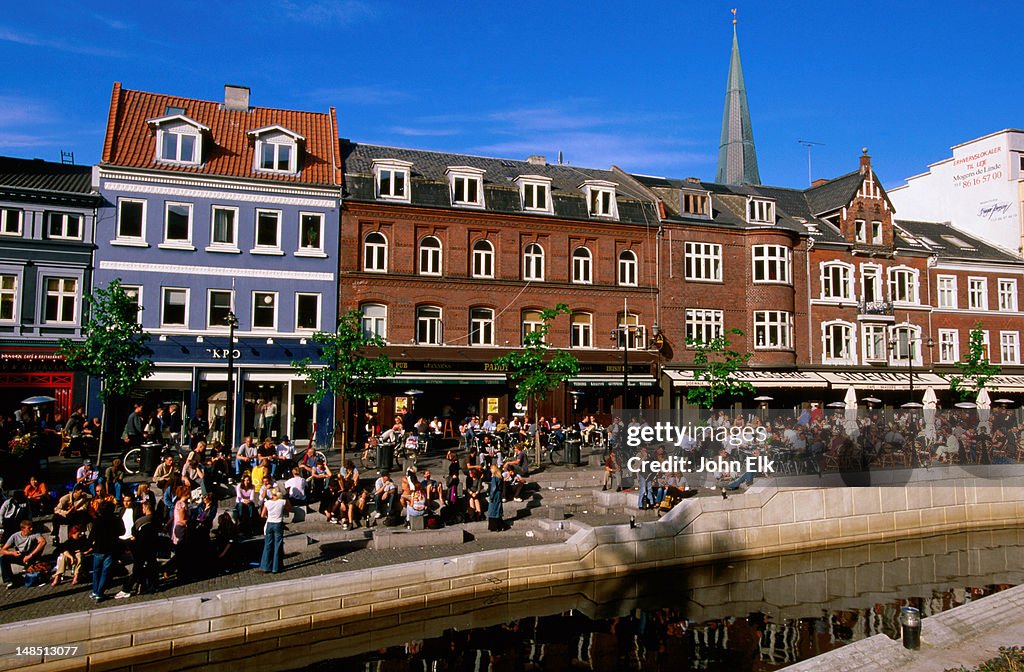 Sidewalk cafes along river.