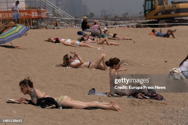 People sunbathe on the beach of Barceloneta, on 25 April, 2023 in Barcelona, Catalonia, Spain. The State Meteorological Agency forecasts that Spain...