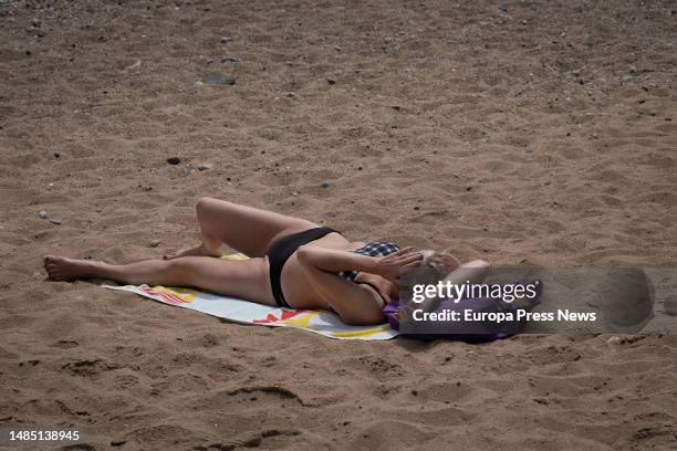 Woman sunbathes on the beach of Barceloneta, on 25 April, 2023 in Barcelona, Catalonia, Spain. The State Meteorological Agency forecasts that Spain...