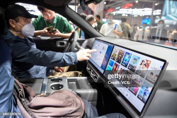 Man stis in a Li Auto SUV during the 20th Shanghai International Automobile Industry Exhibition at the National Exhibition and Convention Center on...