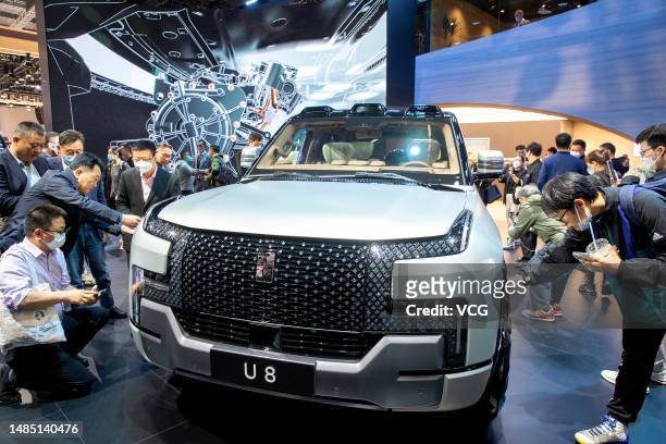 People look at a BYD Yangwang U8 SUV during the 20th Shanghai International Automobile Industry Exhibition at the National Exhibition and Convention...