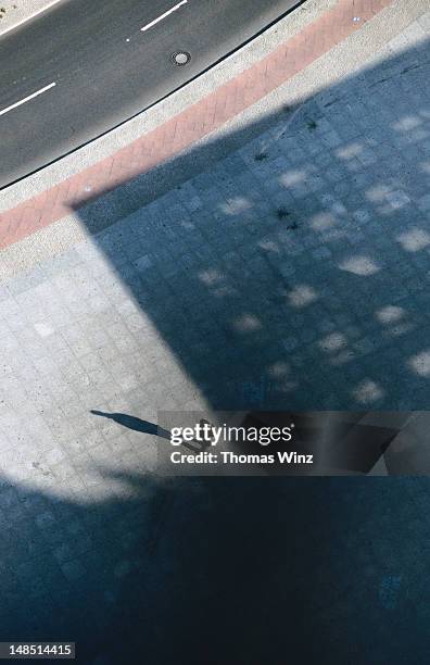 potsdamer platz, person with long shadow. - long shadow stock pictures, royalty-free photos & images