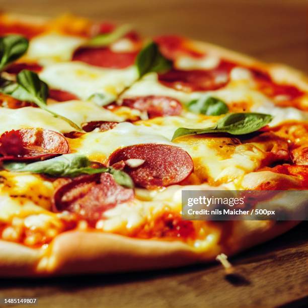 a close-up of a delicious looking pizza with melted chess,ulm,germany - square pizza stock pictures, royalty-free photos & images