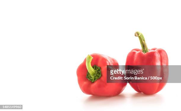 close-up of bell peppers against white background - red pepper stock pictures, royalty-free photos & images