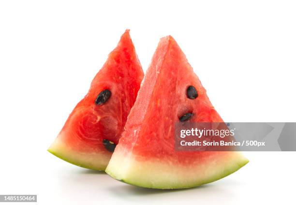 close-up of watermelon slices against white background - watermelon wedge on white stock pictures, royalty-free photos & images