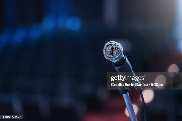 close up of microphone in concert hall or conference room - マイクスタンド ストックフォトと画像