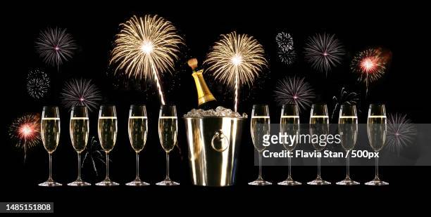 glasses of champagne with silver ice bucket and fireworks,romania - carbonated drink - fotografias e filmes do acervo