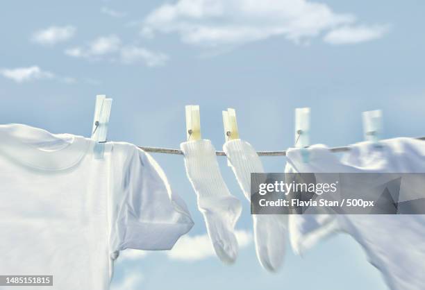 close-up of clothes drying on clothesline against sky,romania - vestito bianco foto e immagini stock