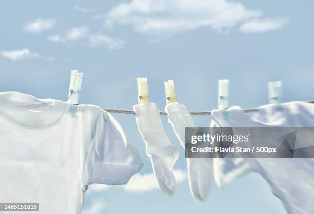 close-up of clothes drying on clothesline against sky,romania - white laundry foto e immagini stock