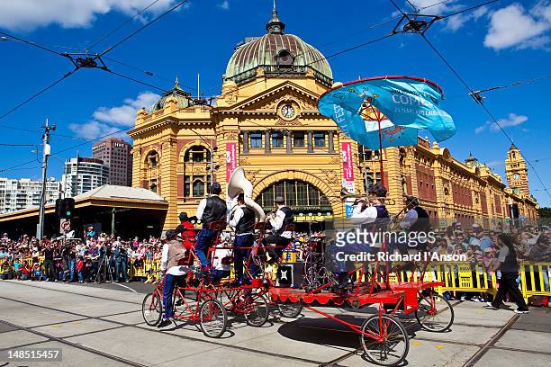 brass band on float in moomba festival parade passing flinders street station. - moomba festival parade stock pictures, royalty-free photos & images