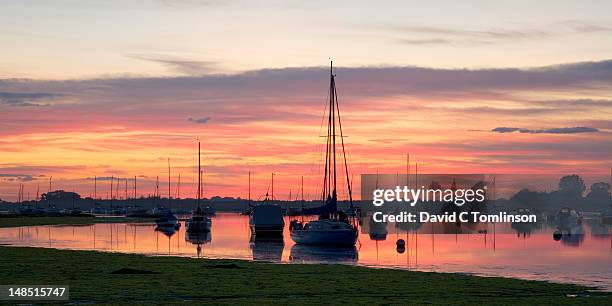 sunset over bosham channel, an inlet of chichester harbour. - chichester harbour stock pictures, royalty-free photos & images