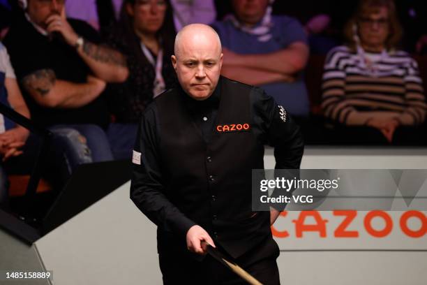 John Higgins of Scotland reacts in the quarter-final match against Mark Selby of England on day 11 of the 2023 Cazoo World Championship at Crucible...