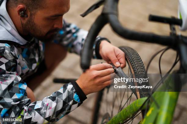 man repairs the punctured bicycle tire - bike tyre stock pictures, royalty-free photos & images