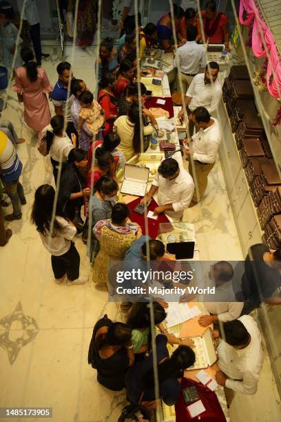 People buy jewellery on the occasion of Dhanteras ahead of the Hindu festival of Diwali at a jewellery store in Agartala. Dhanteras, which occurs two...