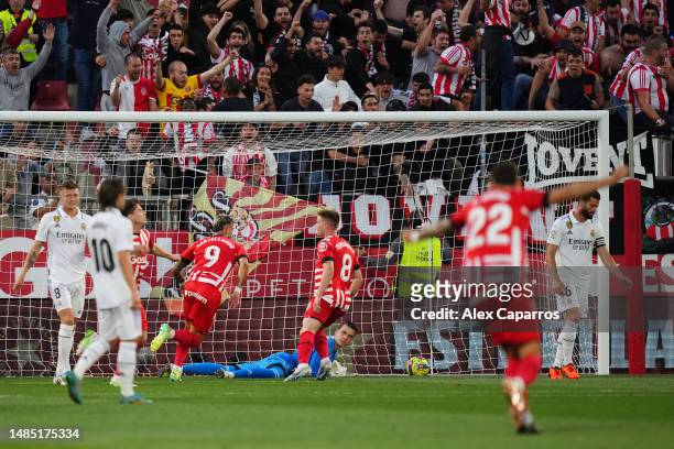 Andriy Lunin of Real Madrid reacts as Valentin Castellanos of Girona FC celebrates after scoring the team's first goal during the LaLiga Santander...