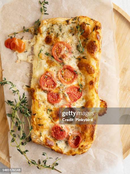 puff pastry pizza, pizza made from puff pastry with cheese, and tomato with thyme leaves, puff pastry margharita pizzas, tomato tart, pastry pita bread,  savory tarts, tomato quiche - vegetarian pizza stock pictures, royalty-free photos & images