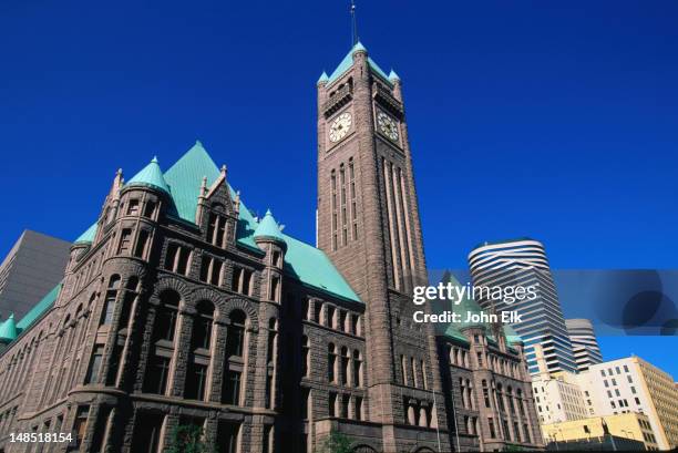 facade of city hall and the courthouse (1887), complete with clock tower - minneapolis-st paul, minnesota - town hall building stock pictures, royalty-free photos & images