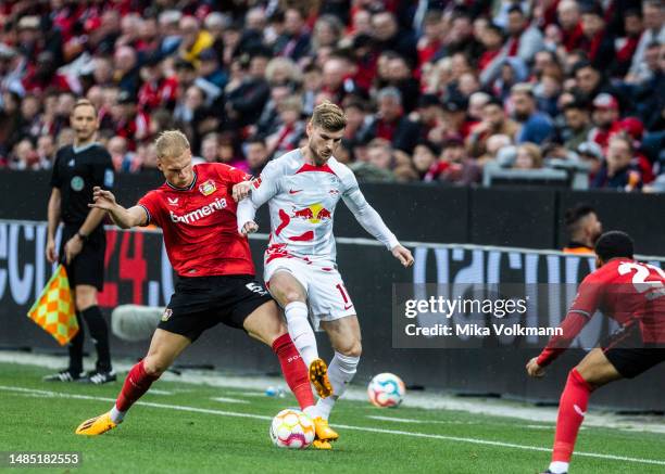 Mitchel Bakker of Leverkusen challenges Timo Werner of Leipzig during the Bundesliga match between Bayer 04 Leverkusen and RB Leipzig at Bayarena on...