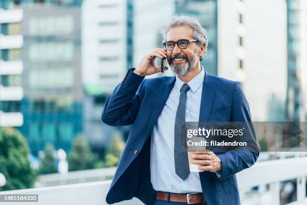 elegant mature man talking on the phone - beard glasses stock pictures, royalty-free photos & images