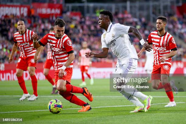 Vinicius Junior of Real Madrid being followed by Arnau Martinez of Girona FC during the LaLiga Santander match between Girona FC and Real Madrid CF...