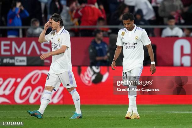 Luka Modric and Rodrygo of Real Madrid look dejected after Valentin Castellanos of Girona FC scores the team's fourth goal during the LaLiga...