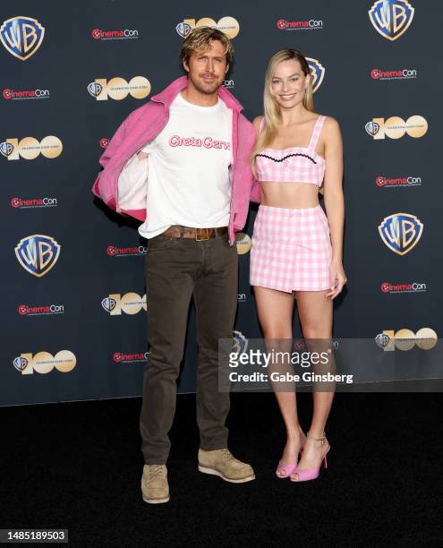 Ryan Gosling and Margot Robbie pose for photos as they promote the upcoming film "Barbie" during the Warner Bros. Pictures presentation at The...