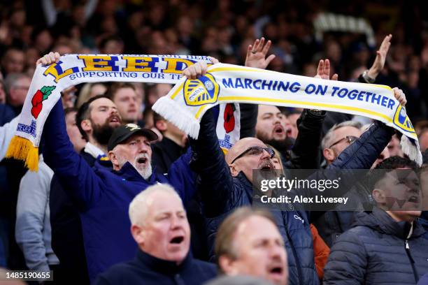 Leeds United fans show their support with scarfs during the Premier League match between Leeds United and Leicester City at Elland Road on April 25,...