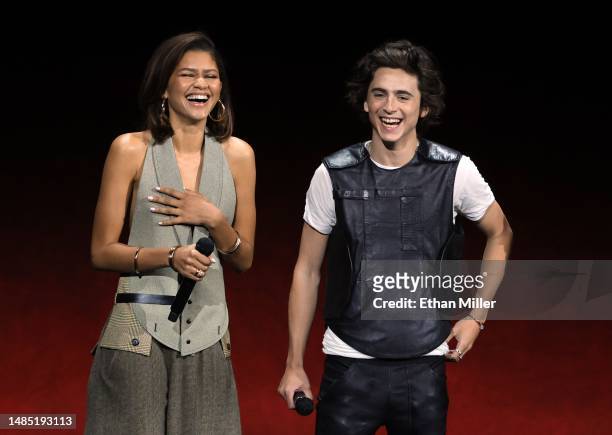 Zendaya and Timothée Chalamet speak onstage as they promote the upcoming film "Dune: Part Two" during the Warner Bros. Pictures Studio presentation...