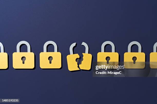 a cracked lock in a group of secure ones, data security - data protection stock pictures, royalty-free photos & images