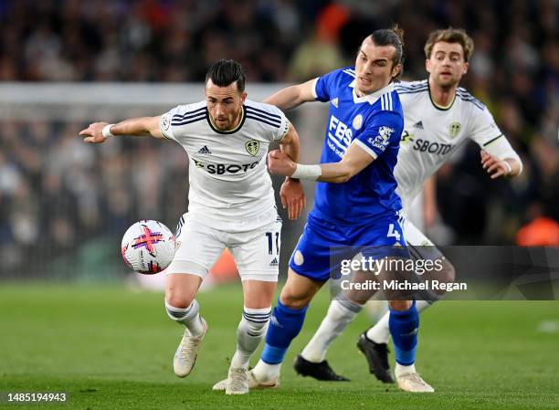 Jack Harrison of Leeds United is challenged by Caglar Soyuncu of Leicester City during the Premier League match between Leeds United and Leicester...