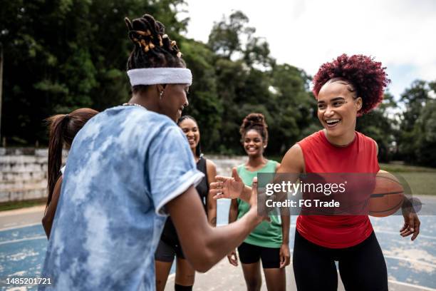 friends greeting in a sports court - basketball competition stock pictures, royalty-free photos & images