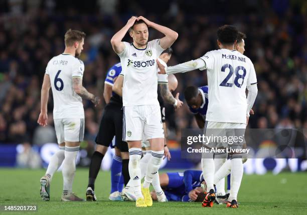 Luke Ayling of Leeds United reacts after receiving a yellow card from Referee Paul Tierney after tackling Harvey Barnes of Leicester City during the...