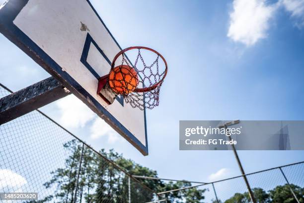 basketball ball falling into the basketball hoop - brazil and outside and ball stock pictures, royalty-free photos & images