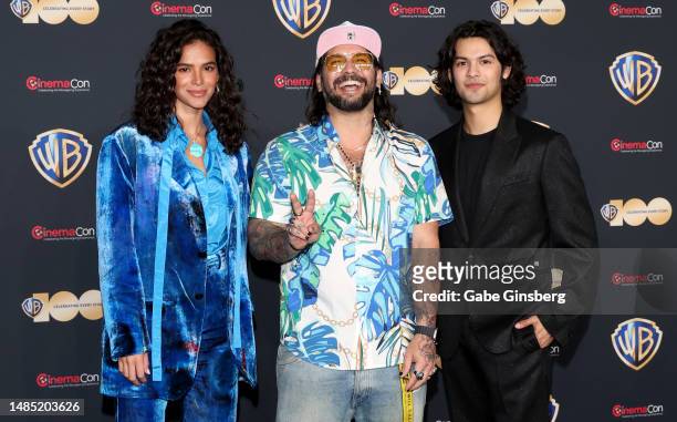 Bruna Marquezine, Angel Manuel Soto and Xolo Mariduena pose for photos as they promote the upcoming film "Blue Beetle" during the Warner Bros....