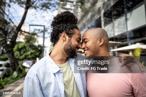 Gay couple embracing in the street Gay couple embracing in the street